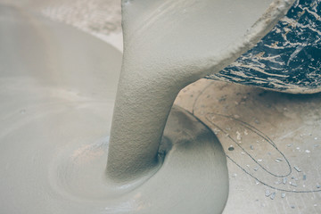 finishing work - the worker does the filling floor poured onto the floor from the bucket