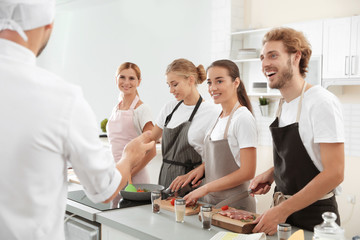 Wall Mural - Group of people and male chef at cooking classes