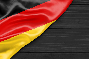 Wall Mural - Flag Germany and space for text on a dark wooden background