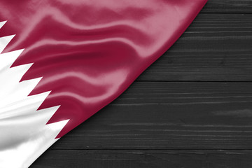 Wall Mural - Flag Qatar and place for text on a dark wooden background