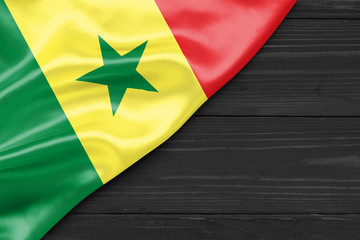 Wall Mural - Flag of Senegal and place for text on a dark wooden background