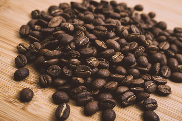 Wall Mural - Coffee beans roasted on a wooden table with much of beans with a great aroma