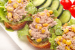 Toast and cucumber appetizers with tuna paste and corn
