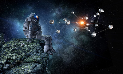 Wall Mural - spaceman on rock edge. mixed media