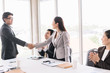 © Sumala - Business group standing handshake  with new friends or colleagues in office room.