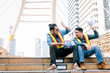 © Sumala - Young engineers sit on the stairs in the city to discuss project work, They are looking for solutions to problems that have been completed within the deadline.