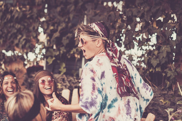 Wall Mural - crazy blonde young woman and girls in friendship all together celebrating and having fun in a bio natural place. smiles and laughing for group of hippies people alternative concept lifestyle