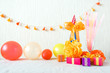 Celebration, Birthday party background with colorful party hat, confetti, gift boxes and other decor. Colorful accessories for parties on wooden table. Copy space