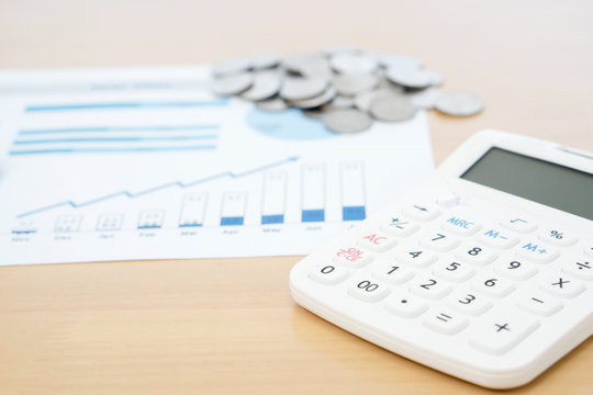 Calculator and stack of coins