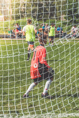 Russia, Leningrad region, Nikolskoye, August 4, 2018 -man, the child, the soccer player is the goalkeeper for the grid