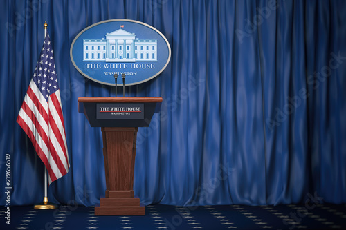 Fotografía Podium speaker tribune with USA flags and sign of White House with space for text