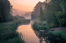 Idyllic River View With Pier And Foggy Sunset At Summer Night In Finland