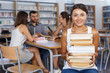 © JackF - Happy girl with books sitting in classroom