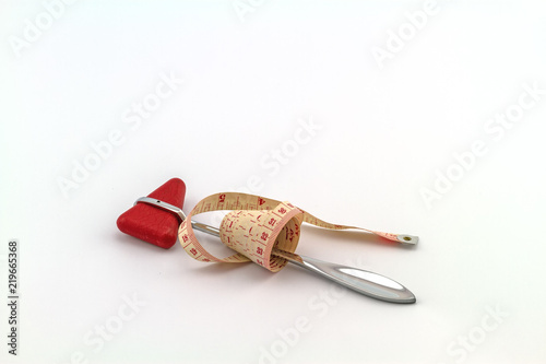 Foto Pink tape measuring and knee jerk medical object on white background