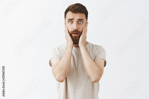 Fotomural Portrait of handsome stylish male entrepreneur starting panic looking concerned