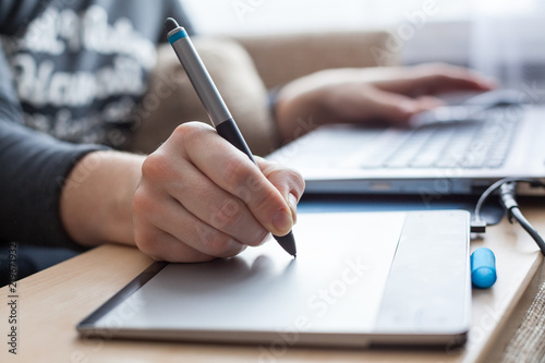 Photographie Close-up view at pen of drawing board painting on surface, woman illustrator