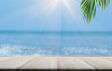 Top Of Wood Table With Blurred Sea And Palm Tree Background,Concept Summer, Beach, Sea, Relax.