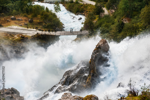 Fotografie, Obraz Kleivafossen waterfall near Briksdal glacier in Norway.