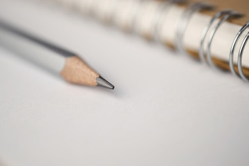 Poster - Macro shot of sharpened pencil on white paper