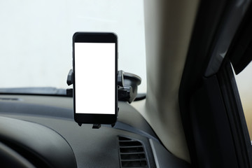Mockup Smartphone in a car use for Navigate or GPS. Smartphone in holder. Mobile phone with isolated white screen.