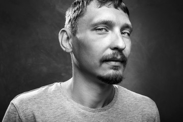 Portrait of a handsome young man, black and white image, close-up front view