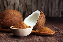 Scoop Of Brown Sugar With Coconut On Wooden Background