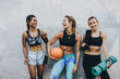 © Jacob Lund - Smiling fitness women standing outdoors after workout