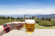 Man holding beer glass in mountain, Krkonose, Czech mountains
