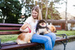 © hedgehog94 - Dog walker enjoying with Pomeranian dogs in park.