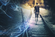 Back View Of A Blurry Man Walks Down The Railway Tracks With Futuristic Computer Cyberspace Sphere Background.