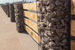  Wooden fence made of horizontal boards with stone pillars. The pillars are made of a metal frame with granite gravel embedded in it. Option of decorative use of gravel.