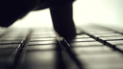Poster - Man typing on computer keyboard. backlit with shallow depth of field. Closeup