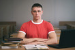 © Dmitriy - Serious student boy writing a lecture or exam work to the workbook.