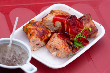 in a street cafe on a plastic table are kebabs and a glass of tea