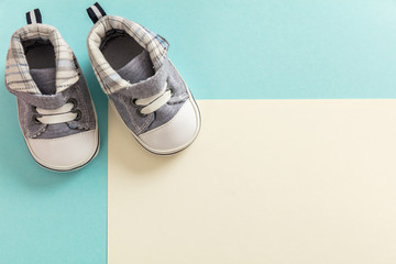 Wall Mural - Baby boy shoes on pastel colors background