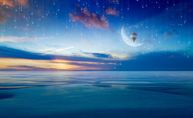 Wall Mural - Colorful hot air balloon in sunrise sky with crescent above serene sea