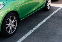 Detail Of Green Shiny Car On Parking Lot