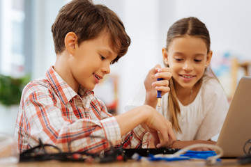 Interest. Schoolchildren dealing with new devices while being at school