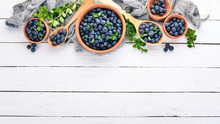 Fresh Berries Of Blueberries. On A Wooden Background. Top View. Free Space For Your Text.
