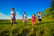 © Svetlana - Group of happy kids running in green summer field