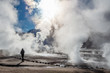 El Tatio geysers in Chile, Silhouette of a woman walking among the steams and fumaroles at sunrise