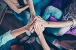 © deagreez - Concept of friendship and success. High top angle view of many hands clasped together