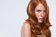 Red Head Girl With Long And Shiny Wavy Hair. Beauty. Beautiful Model Woman With Curly Ginger Hairstyle And Frackles.