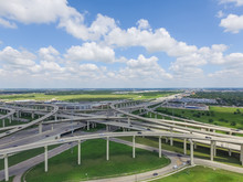 Horizontal Aerial View Interstate 10 Or Katy Freeway Massive Intersection, Stack Interchange, Elevated Road Junction Overpass In Daytime Cloud Blue Sky. Aerial Metropolitan Area Of Katy, Texas, USA