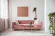 © Photographee.eu - Blurred person against the wall with painting in white flat interior with plant and millenial pink couch. Real photo