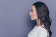 © deagreez - Side profile view of attractive pretty adorable stylish curly-haired girl, isolated over grey background, copy space