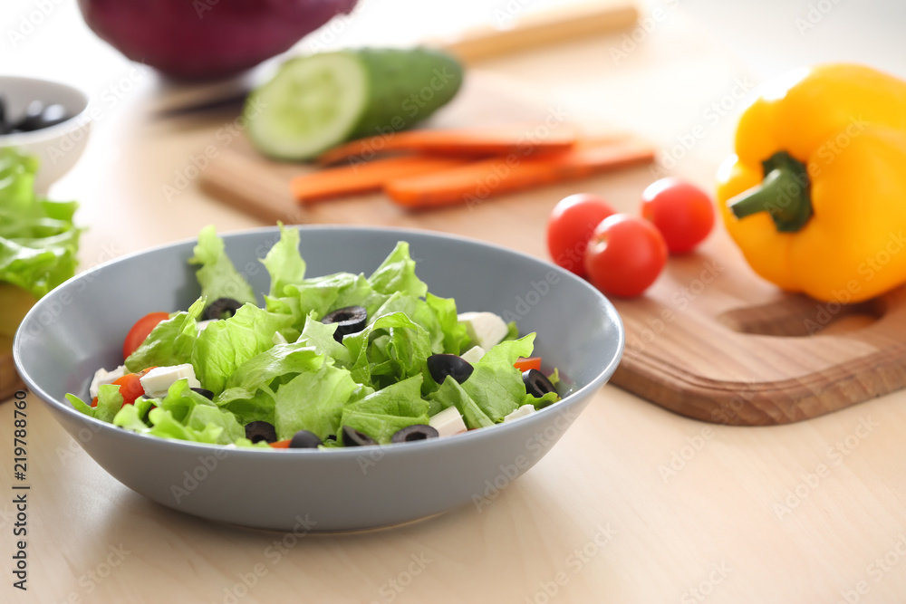Bowl with fresh salad on table. Diet food
