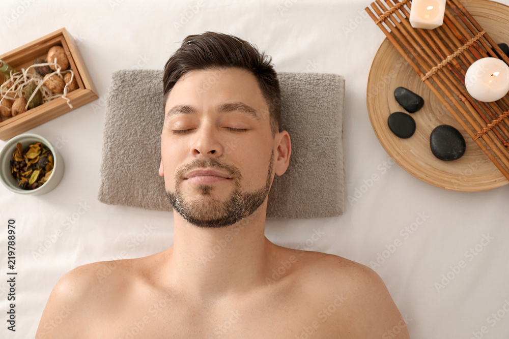 Handsome man relaxing in spa salon
