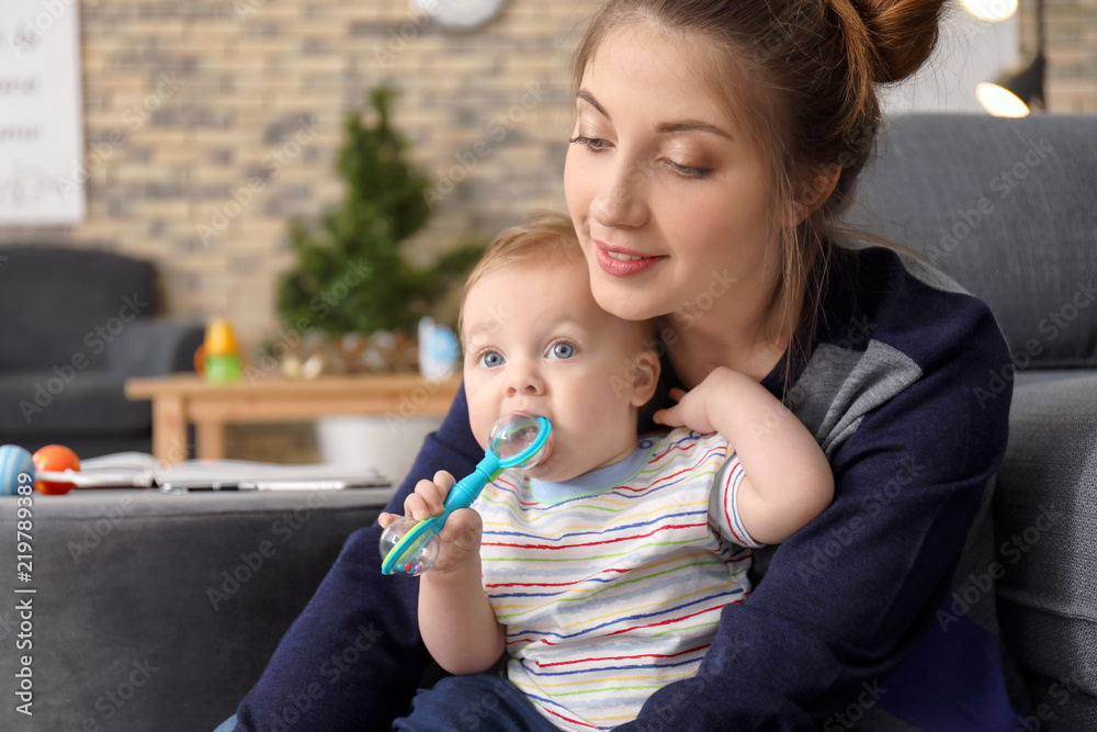 Young mother holding baby at home