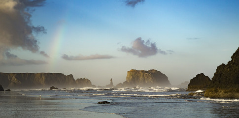 Sunrise with rainbow on Bandon Oregon coast